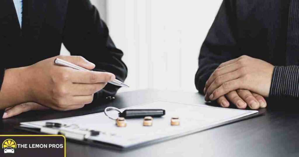 Client discussing a potential lemon law case with an attorney over vehicle documents