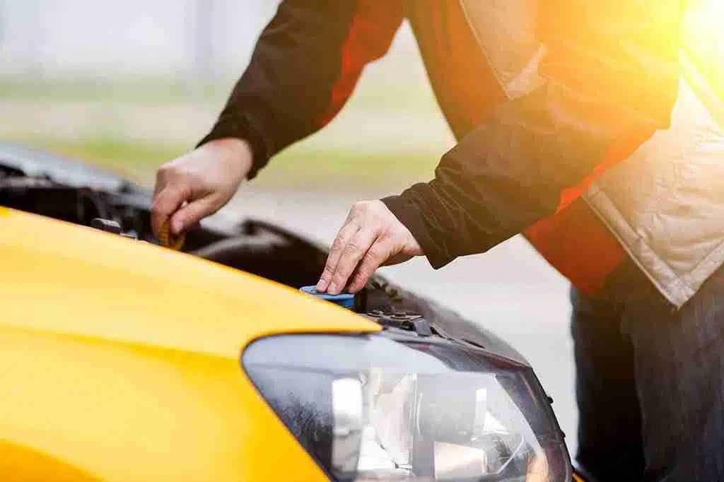 Vehicle owner inspecting engine for mechanical problems after repeated issues